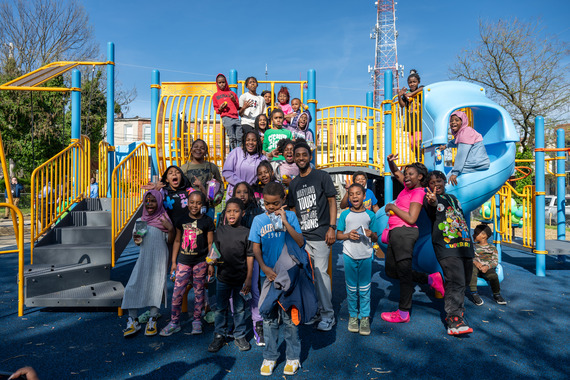 Mayor Brandon M. Scott with children on playground